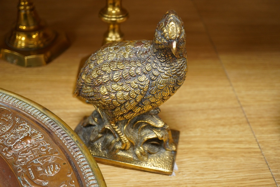A group of copper and brassware to include candlesticks and an alms dish, 45cm in diameter
